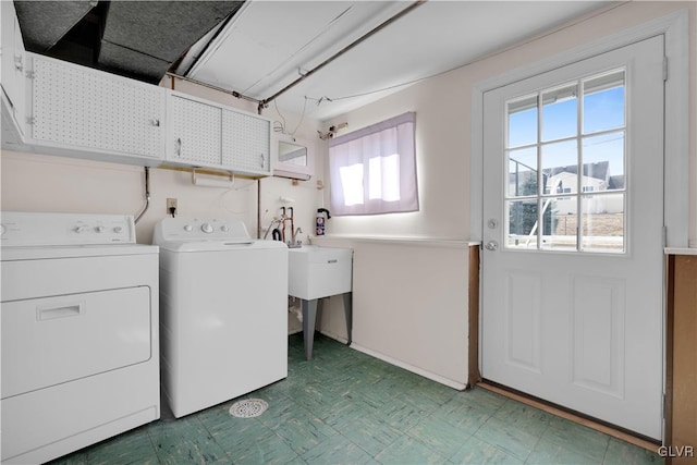 clothes washing area with tile patterned floors, cabinet space, and washing machine and clothes dryer