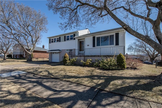 tri-level home featuring concrete driveway and an attached garage