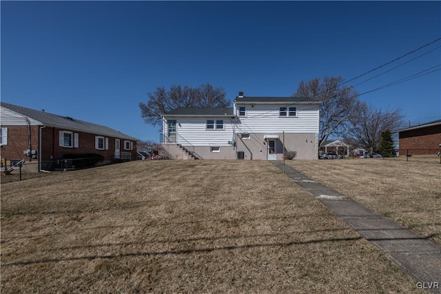 back of house with a yard