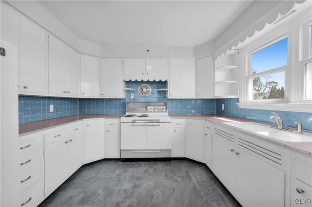 kitchen featuring open shelves, range with two ovens, a sink, white cabinets, and tasteful backsplash