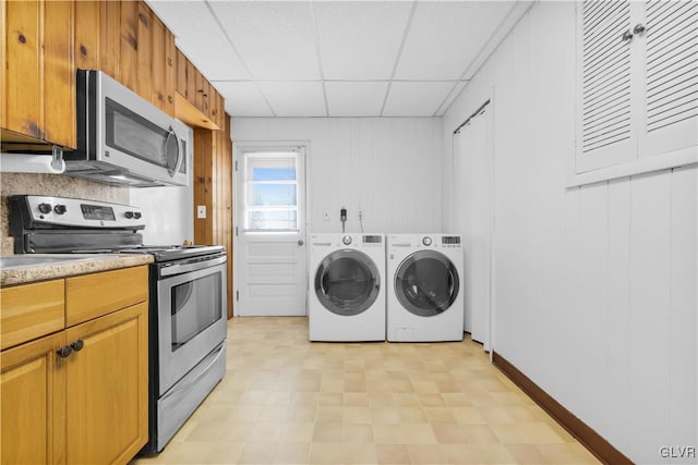 washroom with laundry area, light floors, and washing machine and clothes dryer