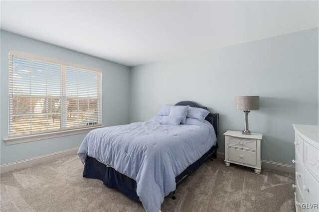 bedroom with baseboards and carpet floors