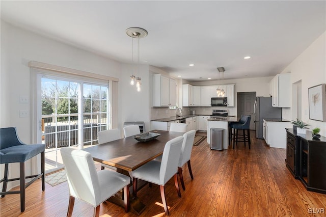 dining room with recessed lighting and dark wood-style flooring