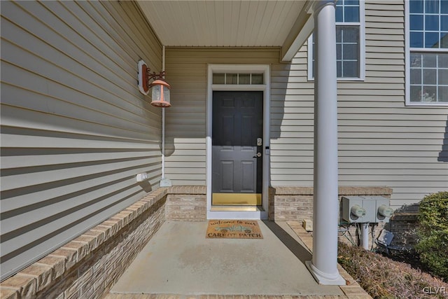 view of exterior entry with brick siding