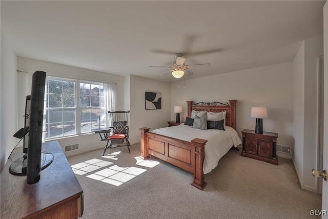 bedroom with light colored carpet, visible vents, and ceiling fan