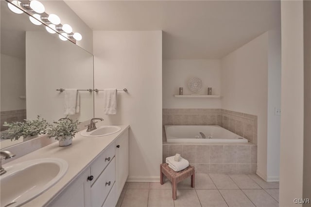 bathroom featuring tile patterned flooring, double vanity, a bath, and a sink