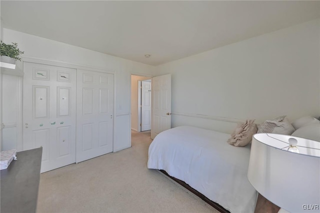 bedroom with a closet and light colored carpet