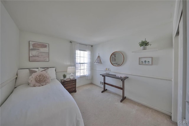 bedroom featuring light carpet and baseboards