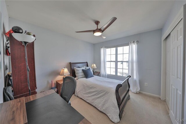 bedroom featuring a closet, baseboards, carpet, and ceiling fan