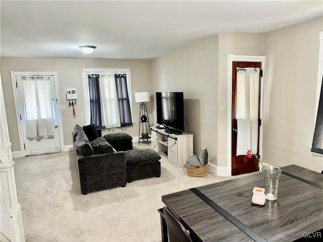 living area with carpet flooring and baseboards