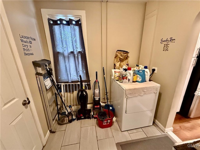 clothes washing area with laundry area, washer / clothes dryer, and wood finish floors