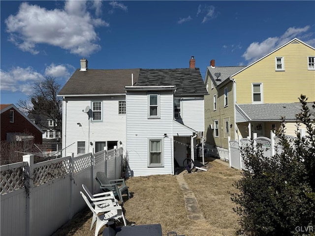 back of property with a fenced backyard