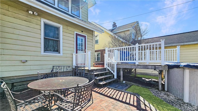 view of patio / terrace featuring outdoor dining area and a deck