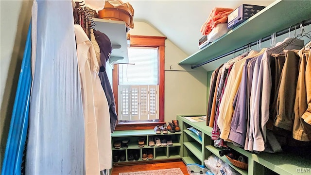 spacious closet with wood finished floors and vaulted ceiling