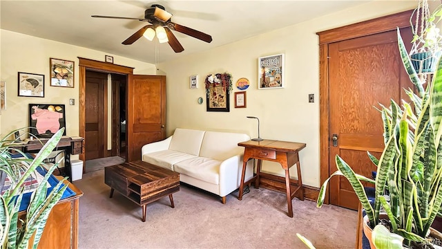 carpeted living area featuring ceiling fan