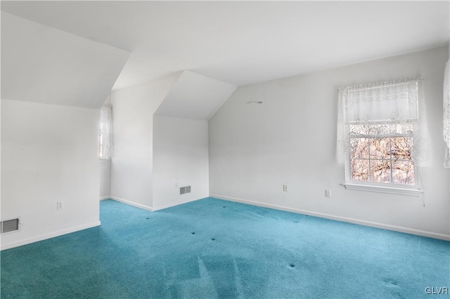 bonus room with visible vents, baseboards, carpet, and vaulted ceiling