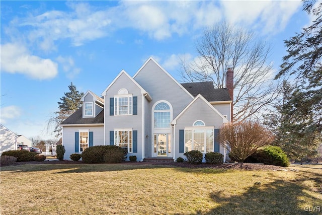 view of front of home featuring a chimney and a front yard