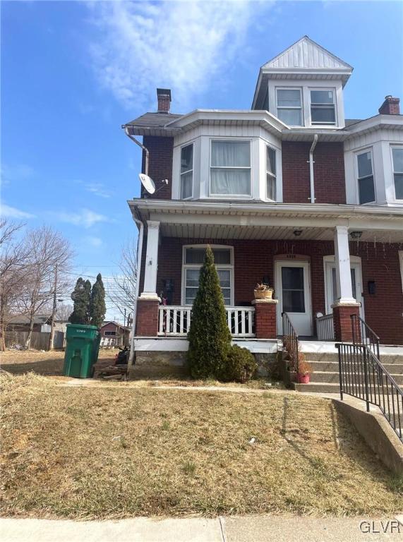 view of front of house with brick siding and covered porch