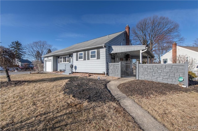 ranch-style home with a gate, fence, an attached garage, and a chimney