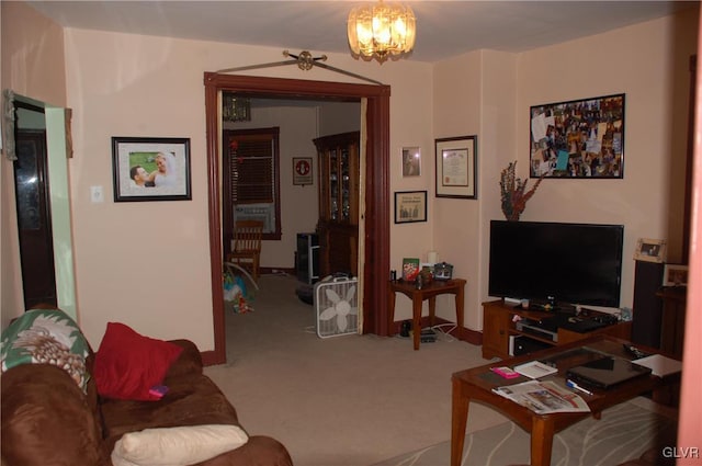 living room with a notable chandelier and carpet