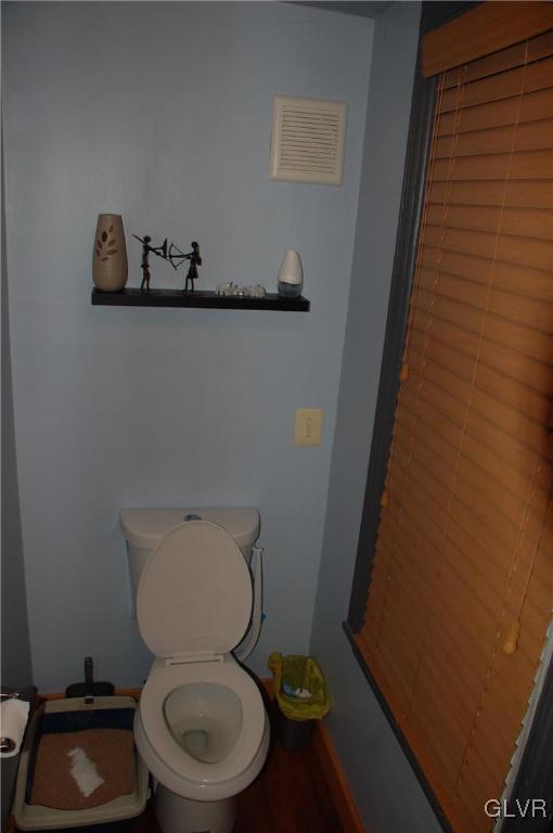 bathroom featuring visible vents and toilet