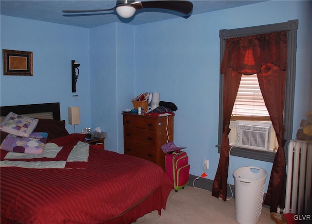 bedroom with cooling unit, radiator, ceiling fan, and carpet flooring