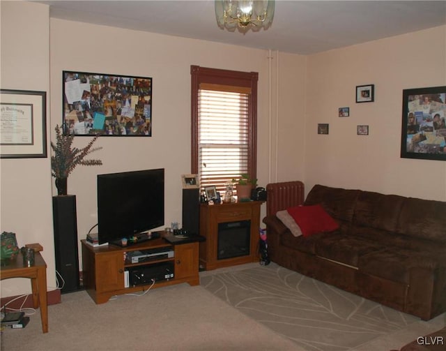 living room featuring a chandelier and light colored carpet