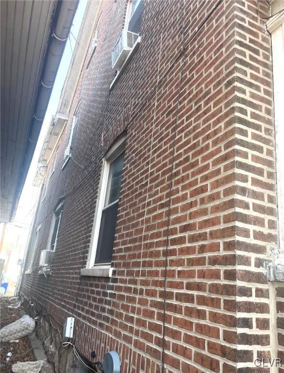 view of home's exterior featuring brick siding and cooling unit