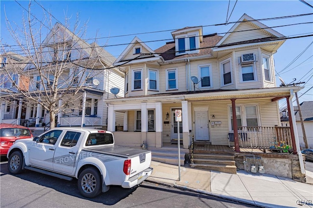 townhome / multi-family property with a porch