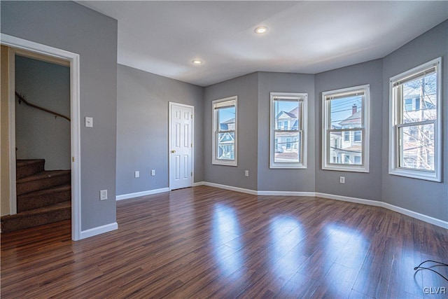 interior space featuring recessed lighting, baseboards, stairs, and dark wood-type flooring