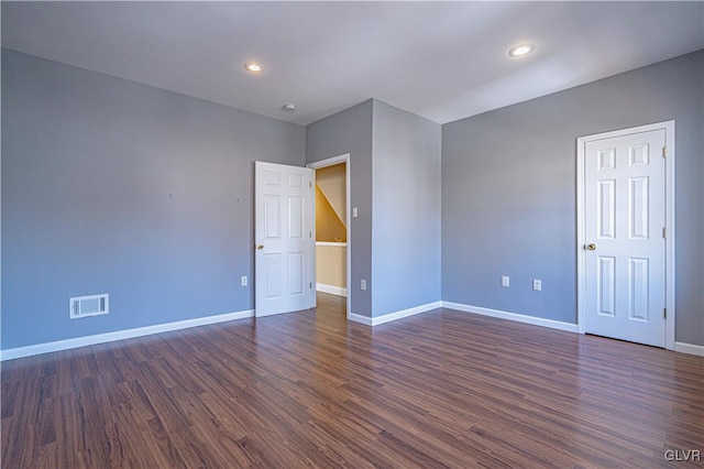 unfurnished room featuring recessed lighting, baseboards, visible vents, and dark wood-style flooring