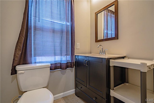 bathroom with vanity, tile patterned floors, toilet, and baseboards