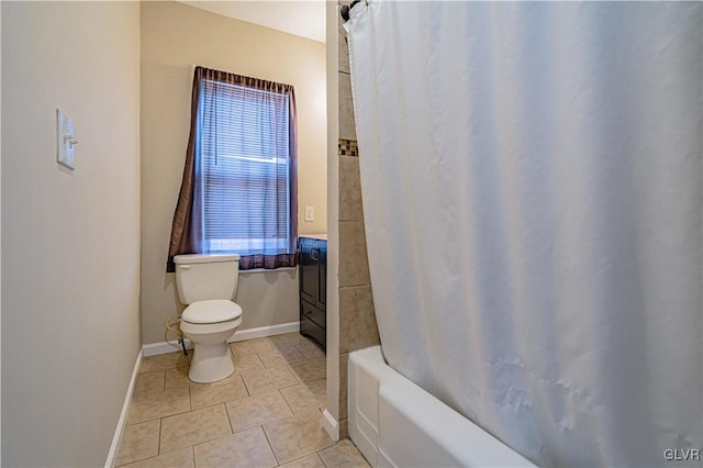 full bath with tile patterned flooring, toilet, shower / tub combo with curtain, and baseboards