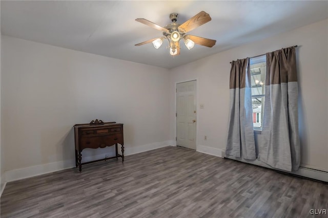 unfurnished room featuring ceiling fan, baseboards, and wood finished floors