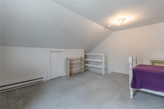 bedroom with vaulted ceiling, baseboard heating, and carpet floors