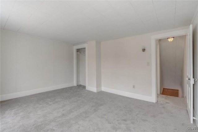 carpeted spare room with baseboards