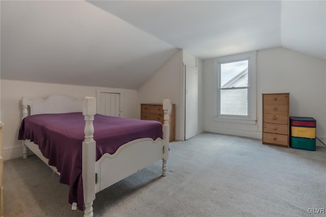 carpeted bedroom featuring vaulted ceiling