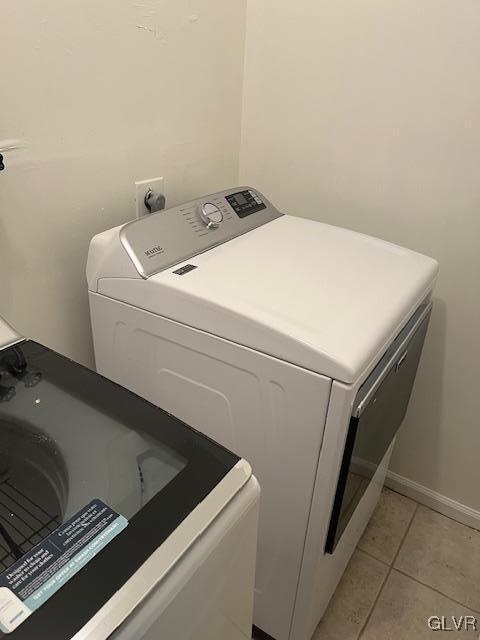 clothes washing area featuring laundry area and light tile patterned floors