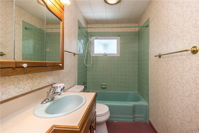 bathroom featuring tile patterned flooring, wallpapered walls, toilet, shower / tub combination, and vanity