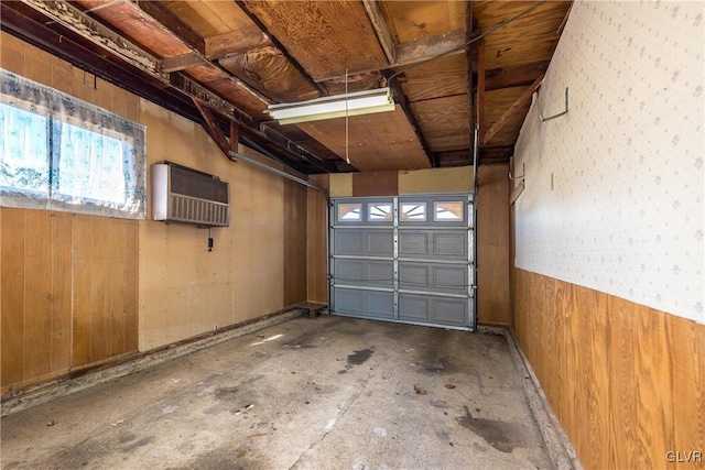 garage featuring a wall unit AC and wood walls