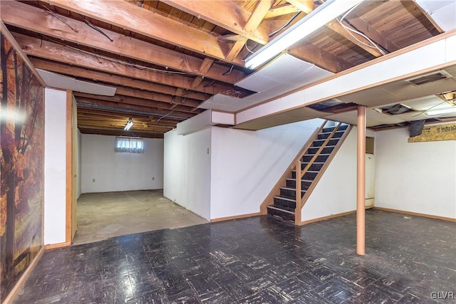 below grade area with visible vents, stairs, and baseboards