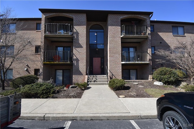 view of building exterior featuring uncovered parking