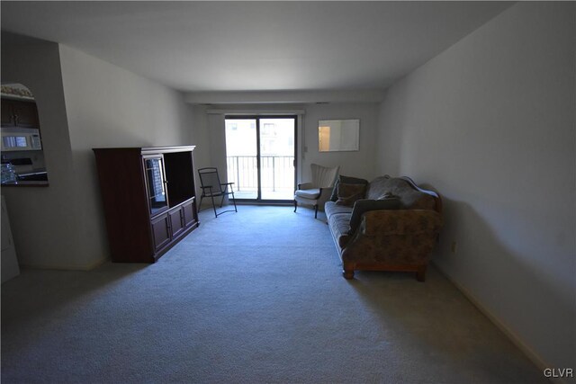 living area featuring light carpet