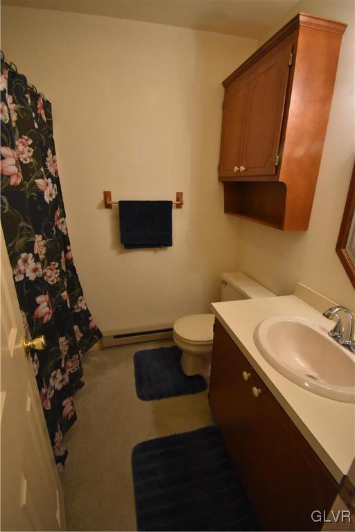 bathroom with toilet, baseboard heating, and vanity