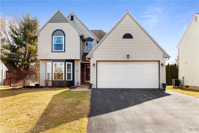 view of front facade with central AC unit, driveway, a front yard, and a garage