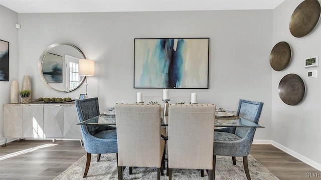 dining room with baseboards and wood finished floors