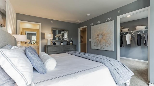 carpeted bedroom featuring a spacious closet, baseboards, and a closet