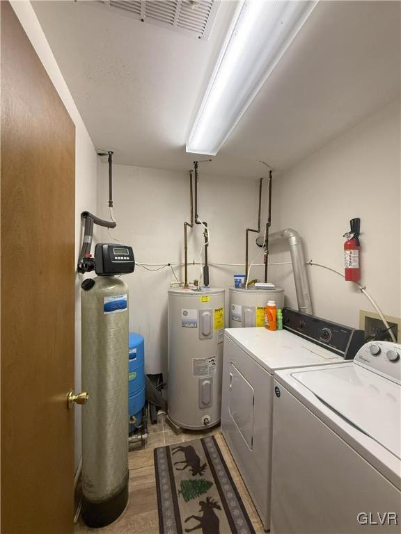 248 Penn Forest Trl, Penn Forest Township, PA 18210 - clothes washing area with laundry area, separate washer and dryer, light wood-style floors, and electric water heater