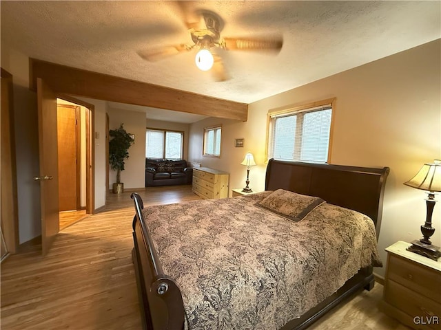 248 Penn Forest Trl, Penn Forest Township, PA 18210 - bedroom with light wood-type flooring, baseboards, a textured ceiling, and ceiling fan