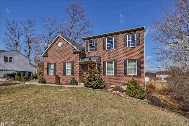 colonial house with brick siding and a front lawn